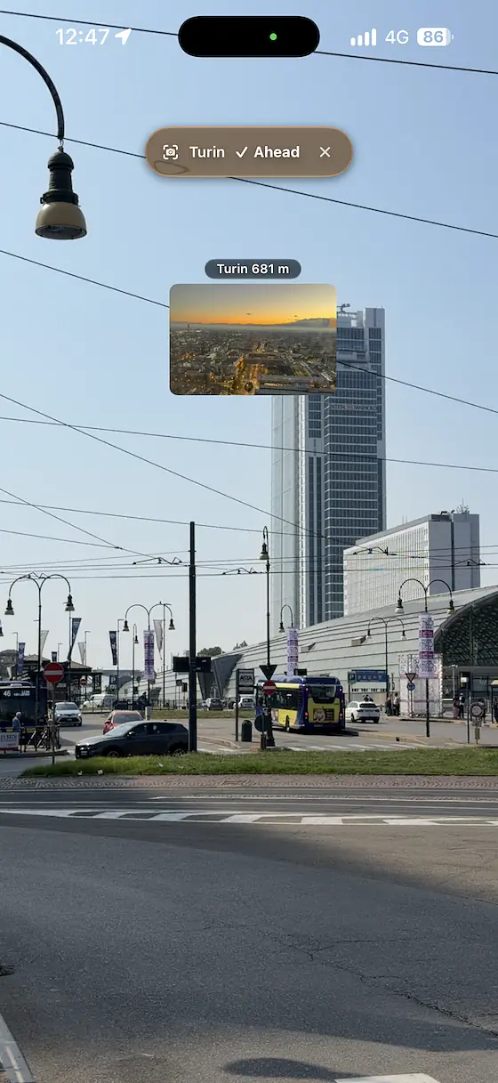 Live camera view of the Intesa Sanpaolo skyscraper in Turin from Porta Susa, with a sunset photo of the city and the Piedmont Region skyscraper pinned to the top of the building, labelled Turin 681 m