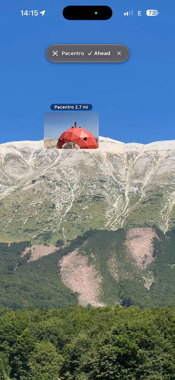 Live camera view from the Monte Amaro ridge in the Majella, Abruzzo, under a clear sky, with a photo of the red Cesare Mario Pelino bivouac pinned on the crest and the label Pacentro 2.7 mi