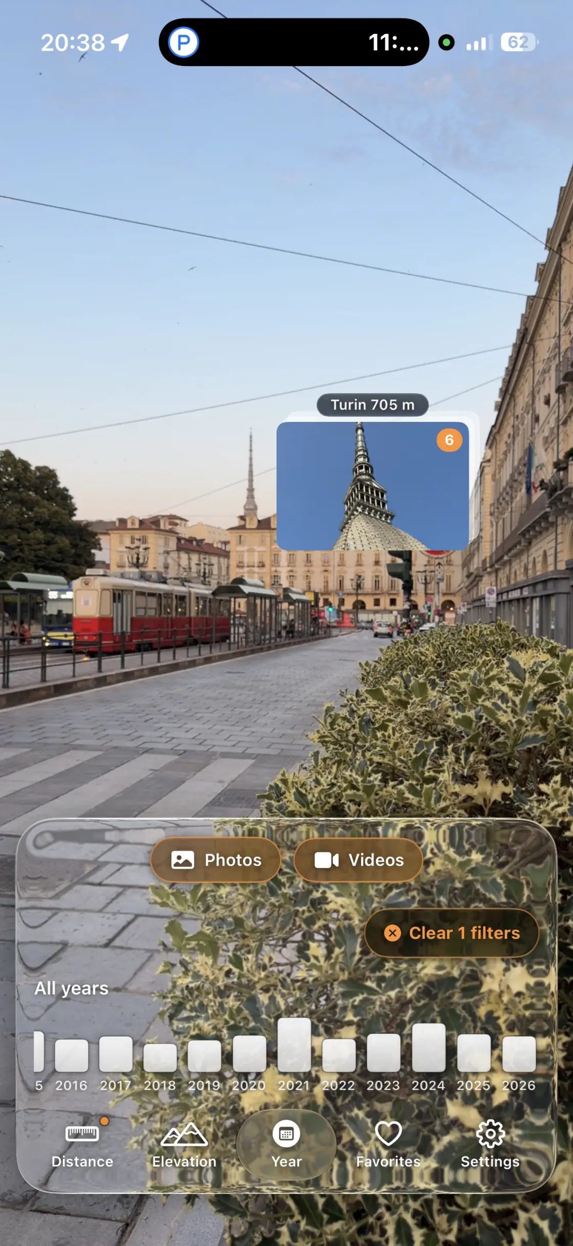 A street in Turin seen through the camera, with a photo of the Mole Antonelliana pinned above the rooftops and its distance, 705 metres